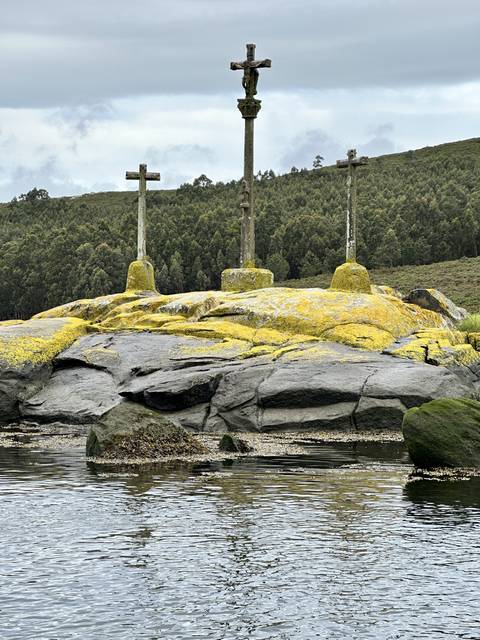 Stone crosses where the trail meets the water.